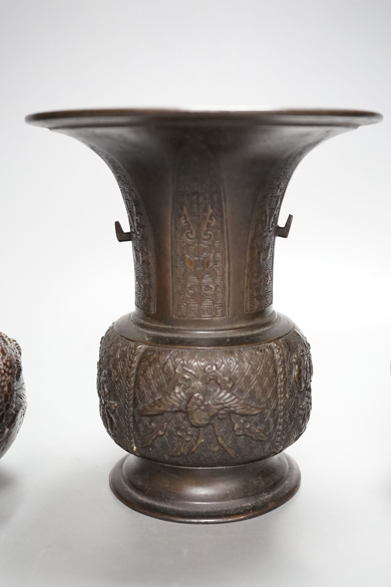 A pair of Japanese Meiji period bronze ‘dragon’ bottle vases and another, 21cm